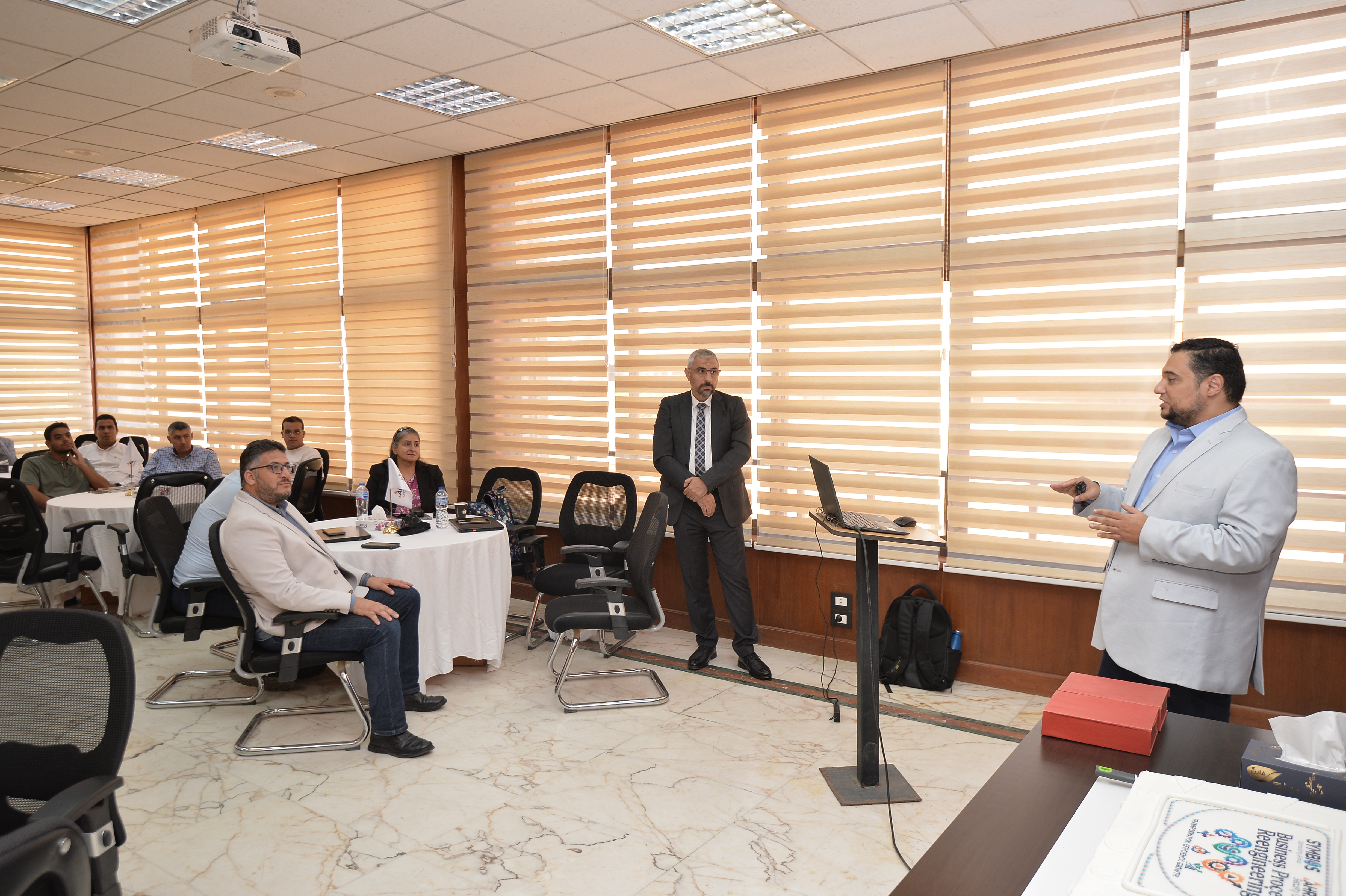 Additional photograph from the Symbios–ASG project closure event, image 6